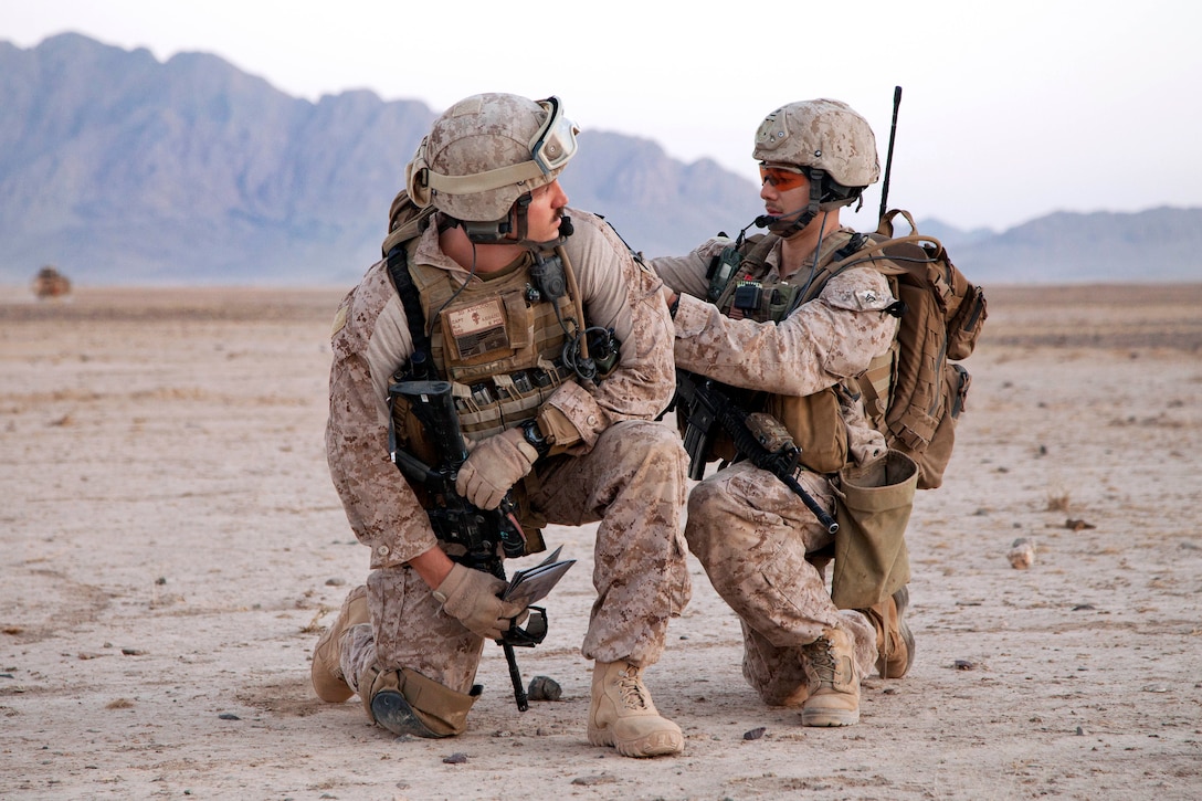 U.S. Marine Corps Cpl. Arnold H. Cabral, left, adjusts U.S. Marine ...