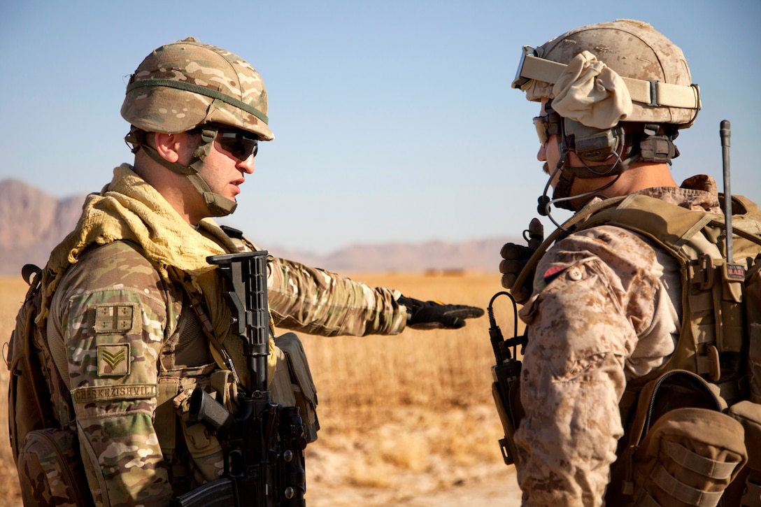 A Georgian soldier, left, talks with U.S. Marine Corps Capt. Bob J ...