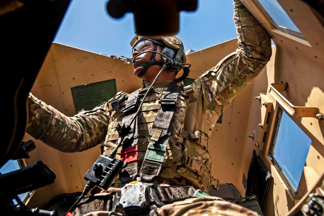 U.S. Army Pvt. 2nd Class Caleb Shain scans his area from the gunners turret during a patrol near Forward Operating Base Salerno in Khowst province, Afghanistan, July 4, 2013. Shain is assigned to the 101st Airborne Division's 2nd Battalion, 506th Infantry Regiment, 4th Brigade Combat Team.