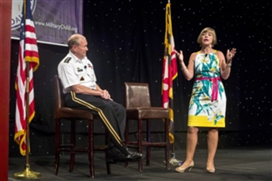 Army Gen. Martin E. Dempsey, chairman of the Joint Chiefs of Staff, and his wife, Deanie, speak at the kickoff of the Military Child Education Coalition’s 15th National Training Seminar in National Harbor, Md., July 8, 2013. The coalition works with leading national experts in child development, education and health to support military children.