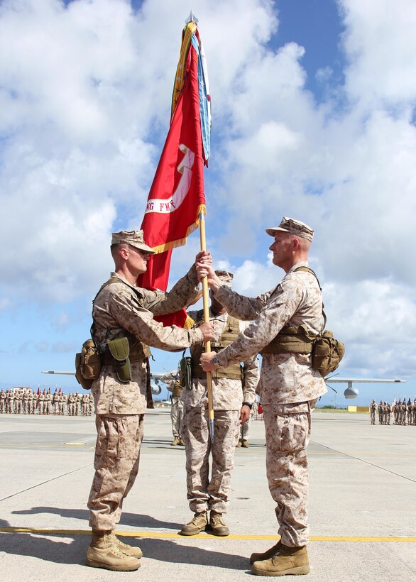 Maj. Gen. Christopher S. Owens, right, passes the 1st Marine Aircraft Wing colors to Brig. Gen. Steven R. Rudder July 9 during the 1st MAW change of command ceremony at Marine Corps Air Station Futenma. Owens will become the commanding general of U.S. Marine Forces Korea and the assistant chief of staff, C/J-5 plans, policy and strategy, United Nations Command, Combined Forces Command, U.S. Forces Korea. Rudder’s previous assignment was at Headquarters Marine Corps where he served as the legislative assistant to the commandant of the Marine Corps. 1st MAW is part of III Marine Expeditionary Force. (U.S. Marine Corps photo by Lance Cpl. Donald T. Peterson/Released) 