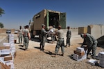 Members of 3rd Battalion, 157th Field Artillery of the Colorado Army National Guard unload mail from a vehicle filled with many packages and letters from home Sept. 10, 2009 at Camp Ramadi, Iraq. (Photo by 