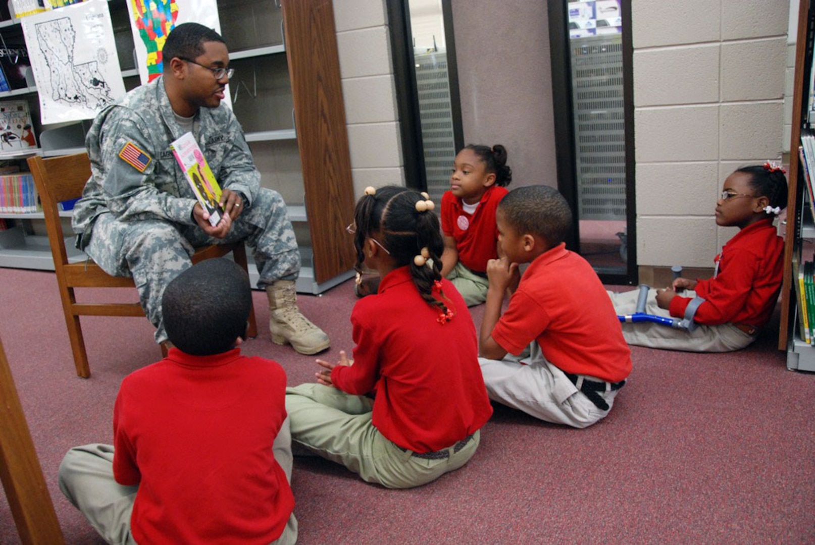 Louisiana Army National Guardsman Capt. Lance T. Cagnolatti reads to a groups of students at East Iberville School in St. Gabriel, La., as part of the "Real Men Read" program that teaches kids the importance of reading.