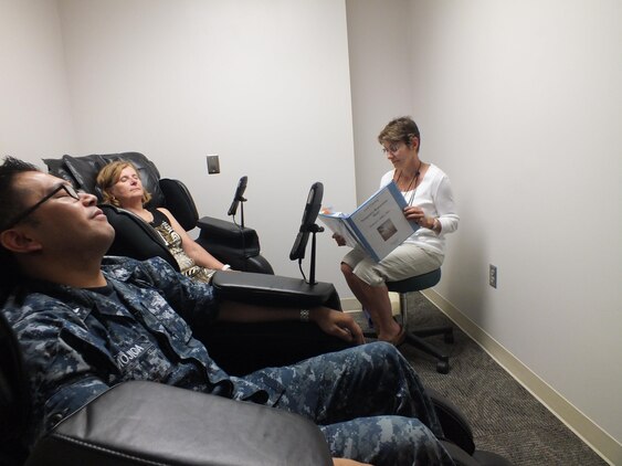 Petty Officer 2nd Class Brian Mojica, lead petty officer for pediatrics at Naval Health Clinic Quantico, and Nancy Walker, nurse health educator, relax as Patricia Padgett, the nurse health educator in charge of the clinic’s iRest yoga nidra program, guides their meditation. 