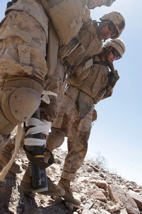 Marines with Company A, 1st Battalion, 24th Marine Regiment, use an empty rocket tube to stabilize the leg of a notional casualty during a company-size assault on Range 400 as part of Integrated Training Exercise 4-13 at the Marine Corps Air Ground Combat Center, here, June 20. ITX is the largest annual Marine Forces Reserve training exercise and a cornerstone of the Marine Air Ground Task Force Training Program, with more than 5,000 Marines participating from units across the United States, utilizing assets from ground, air and logistic combat elements.  (U.S. Marine Corps photo by Cpl. John M. McCall)