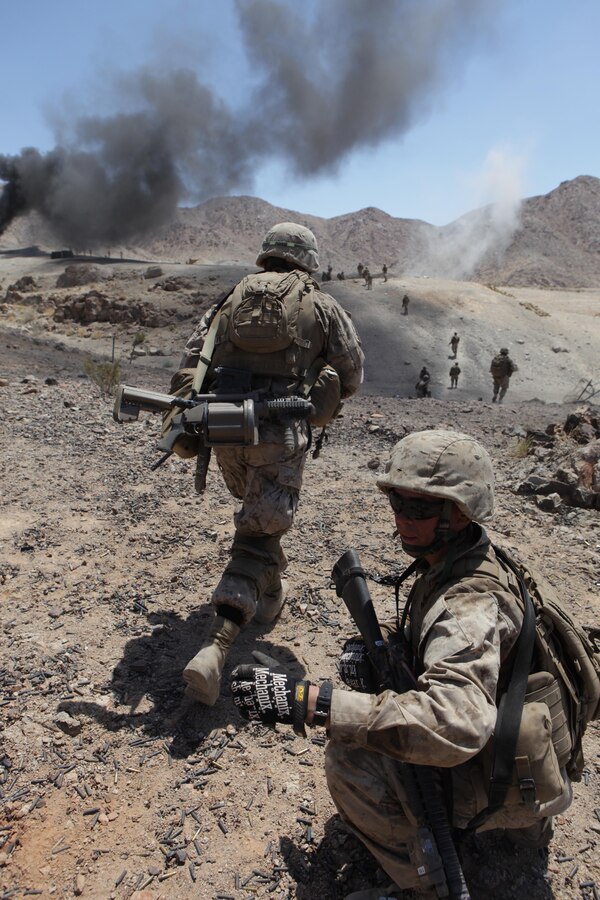 Lance Cpl. Matthew Gay, a combat engineer with Company A, 1st Battalion, 24th Marine Regiment, a native from Harrisville, W. Va., directs Marines across a danger area during a company-size assault on Range 400 as part of Integrated Training Exercise 4-13 at the Marine Corps Air Ground Combat Center, June 20. ITX is the largest annual Marine Forces Reserve training exercise and a cornerstone of the Marine Air Ground Task Force Training Program, with more than 5,000 Marines participating from units across the United States, utilizing assets from ground, air and logistic combat elements. (U.S. Marine Corps photo by Cpl. John M. McCall)