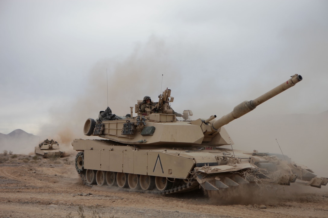 TWENTYNINE PALMS, Calif. – Marines with 4th Tank Battalion, 4th Marine Division maneuver M1A1 Abrams tanks toward simulated enemy positions during the mechanized assault course at the Marine Corps Air Ground Combat Center here June 23. The Marines were participating in Integrated Training Exercise 4-13, a cornerstone of the Marine Air Ground Task Force Training Program. It is the largest annual U.S. Marine Corps Reserve training exercise helping to establish best practices and refine planning guidance and baseline requirements for future Reserve units. ITX 4-13, utilizing assets from Ground, Air and Logistic Combat Elements is a live, virtual, constructive battalion exercise. (U.S. Marine Corps photo by Cpl. John M. McCall)