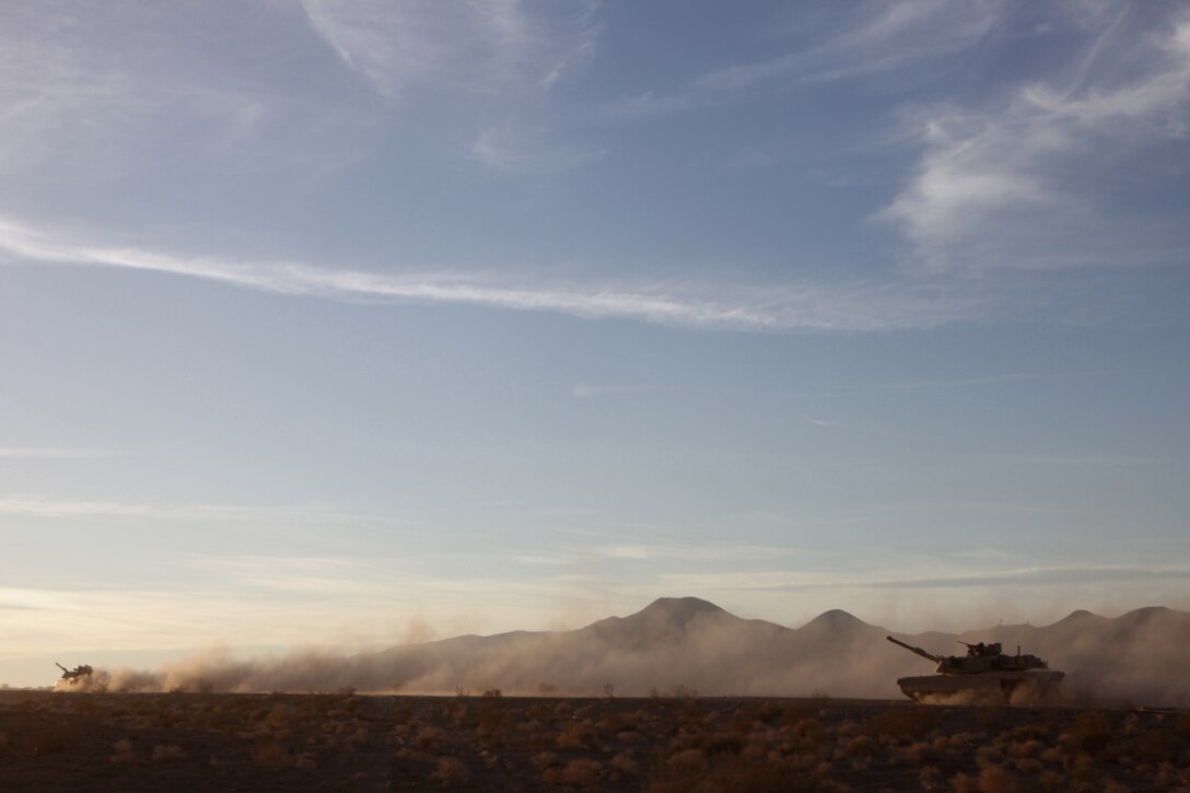 TWENTYNINE PALMS, Calif. – Marines with 4th Tank Battalion, 4th Marine Division maneuver M1A1 Abrams tanks toward a simulated enemy position during the mechanized assault course at the Marine Corps Air Ground Combat Center here June 23. The Marines were participating in Integrated Training Exercise 4-13, a cornerstone of the Marine Air Ground Task Force Training Program. It is the largest annual U.S. Marine Corps Reserve training exercise helping to establish best practices and refine planning guidance and baseline requirements for future Reserve units. ITX 4-13, utilizing assets from Ground, Air and Logistic Combat Elements is a live, virtual, constructive battalion exercise. (U.S. Marine Corps photo by Cpl. John M. McCall)
