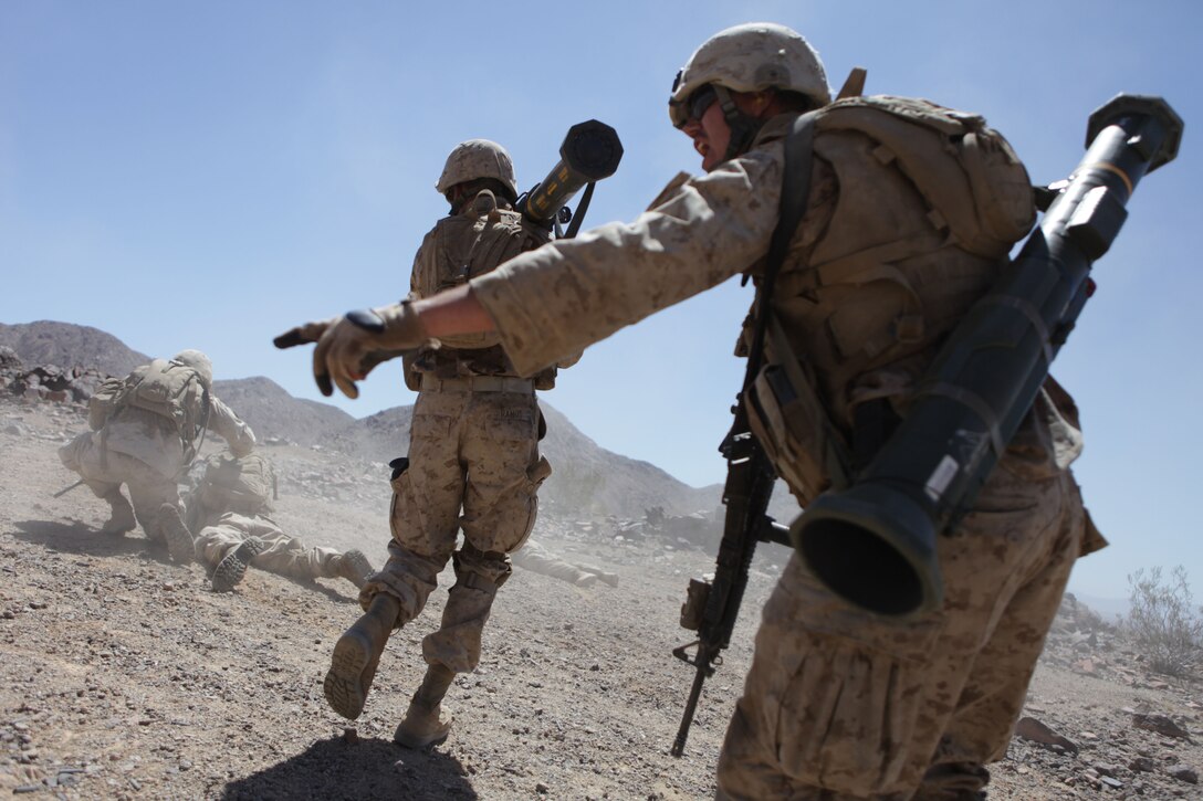 Assaultmen with Company A, 1st Battalion, 24th Marine Regiment, rush toward the firing line during a company-size assault on range 400 as part of Reserve Integrated Training Exercise 4-13 at the Marine Corps Air Ground Combat Center, June 20. R-ITX is the largest annual Marine Forces Reserve training exercise and a cornerstone of the Marine Air Ground Task Force Training Program, with more than 5,000 Marines participating from units across the United States, utilizing assets from ground, air and logistic combat elements. (U.S. Marine Corps photo by Cpl. John M. McCall)