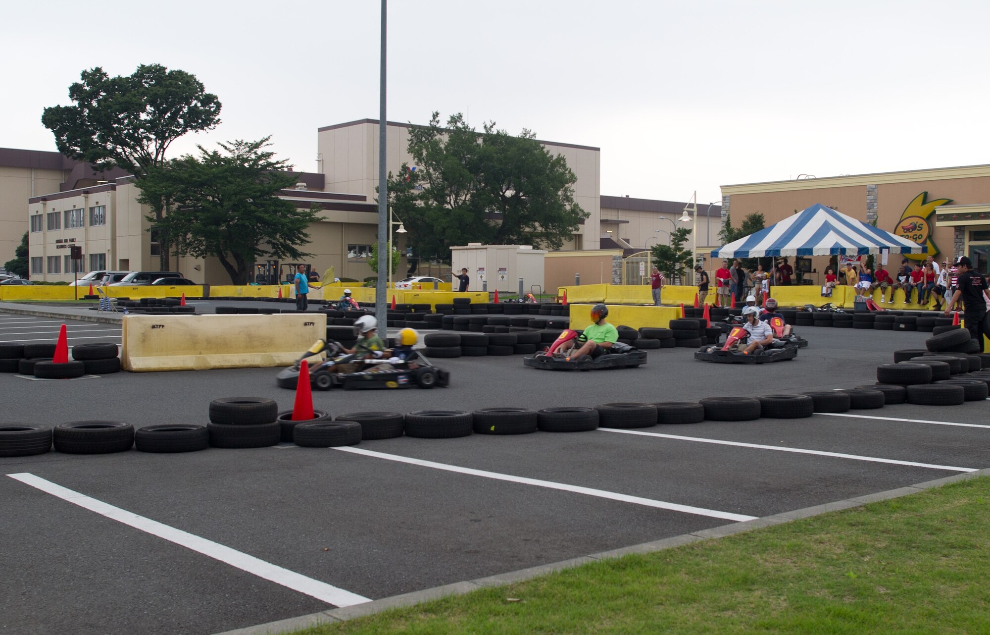 YOKOTA AIR BASE, Japan -- Adults and children drive go-carts during the Celebrate America festival at Yokota Air Base, Japan, July 4, 2013. The festivities also included free food, carnival games, bouncy castles and a petting zoo. (U.S. Air Force photo by Senior Airman Andrea Salazar/Released)