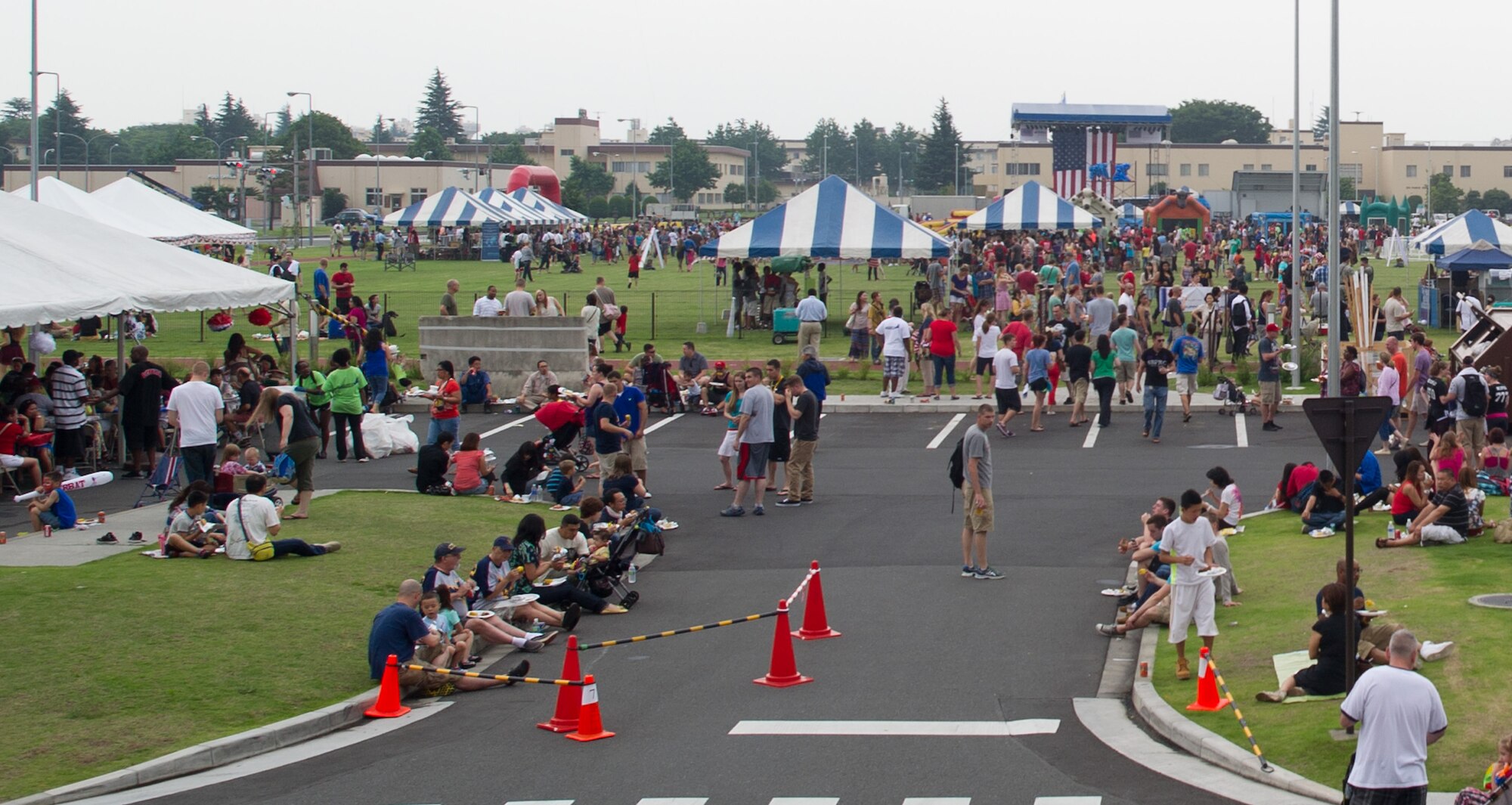 YOKOTA AIR BASE, Japan -- Yokota members visit various tents and activities during the Celebrate America festival at Yokota Air Base, Japan, July 4, 2013. The event included free food, carnival games, live music and a fireworks show. (U.S. Air Force photo by Senior Airman Andrea Salazar)