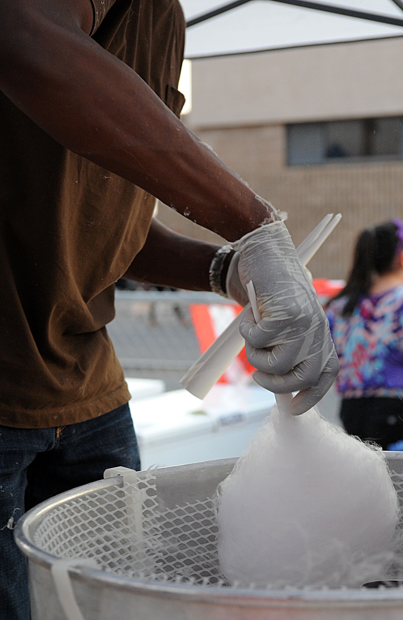 U.S. Air Force Chief Master Sgt. Timothy Ross, 355th Equipment Maintenance Squadron first sergeant, prepares cotton candy for patrons of the Independence Day Celebration at Davis-Monthan Air Force Base, Ariz., July 4, 2013. The celebration was held at Bama Park here, and culminated in a 25-minute fireworks display. (U.S. Air Force photo by Senior Airman Timothy Moore/Released)