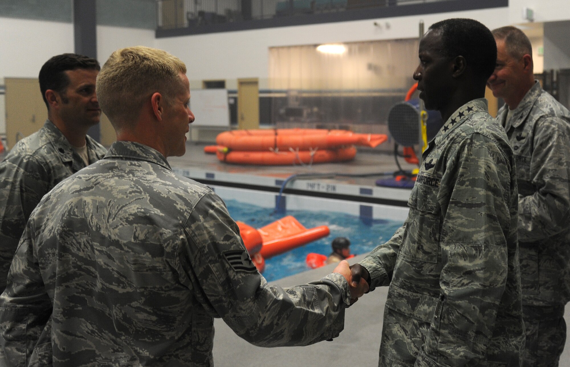 Gen. Edward Rice, commander of the Air Education and Training Command, exchanges thanks with Survival, Evasion, Resistance and Escape Airmen at the water training facility at Fairchild Monday, July 1, 2013.  While on base, the general was able to speak to Airmen about sequestration.  (U.S. Air Force photo by Airman 1st Class Sam Fogleman/Released)