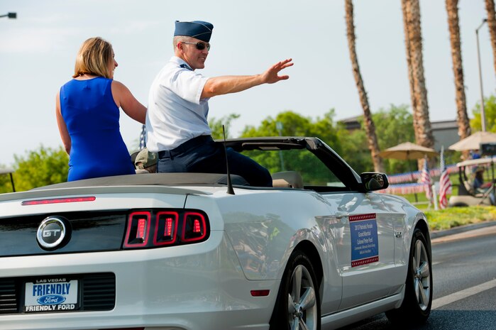 Col. Peter Ford, 57th Adversary Tactics Group commander, and his wife, Jennifer, wave to onlookers during the 19th Annual Summerlin Council Independence Day Parade July 4, 2013, in Las Vegas. Ford represented Nellis Air Force Base as the co-grand marshal of the event alongside Nevada Gov. Brian Sandoval.  (U.S. Air Force photo by Staff Sgt. Michael Charles)