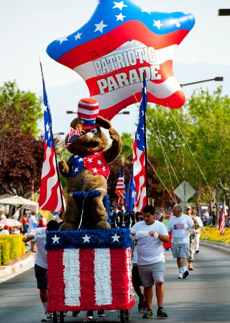 Volunteers from the Summerlin community push the Summerlin Independence Day Parade mascot July 4, 2013, during the 19th Annual Summerlin Council Independence Day Parade in Las Vegas. Organizations from southern Nevada participated in the event to celebrate the birth of the nation and, according to the event organizers, raise morale in the community.  (U.S. Air Force photo by Staff Sgt. Michael Charles)