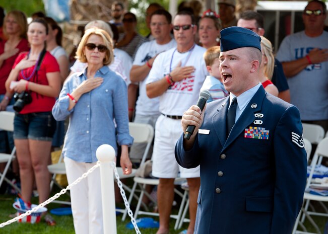 Staff Sgt. Benjamin Ekblad, 99th Civil Engineer Squadron structural journeyman, sings the national anthem July 4, 2013, during the 19th Annual Summerlin Council Independence Day Parade in Las Vegas. Every year Summerlin hosts an Independence Day parade to celebrate the birth of the nation. (U.S. Air Force photo by Staff Sgt. Michael Charles)