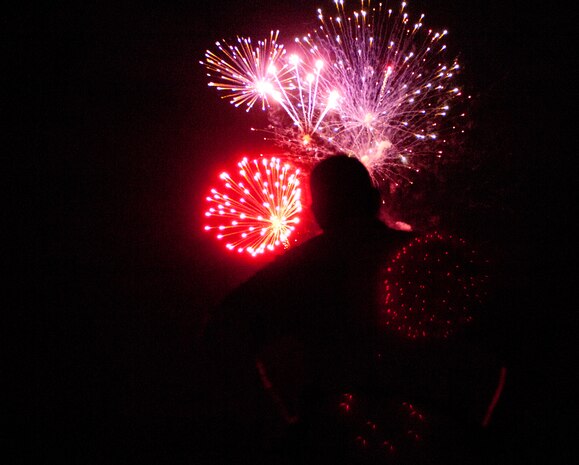 An Airman from the 432nd Maintenance Squadron, Las Vegas, watches a fireworks display during an Independence Day celebration July 4, 2013, at the Las Vegas Country Club. Airmen from the 432nd AMXS and other units attended the event and educated the public about their mission while enjoying food, music and fireworks. (U.S. Air Force photo by Airman 1st Class Joshua Kleinholz) 