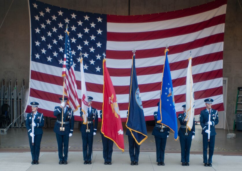 Ellsworth Air Force Base Honor Guard members present the U.S. flag and five flags representing each military branch during a military appreciation ceremony held in conjunction with Independence Day activities at the Mount Rushmore National Memorial in South Dakota, July 3, 2013. Airmen, their families and members of the local community honored military members for their service to their nation during the event. (U.S. Air Force photo by Airman 1st Class Zachary Hada/Released)