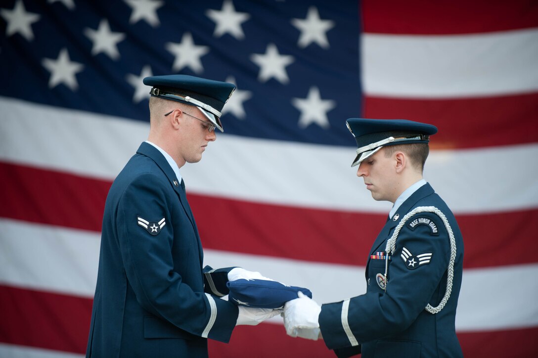 Ellsworth Air Force Base Honor Guard members perform a flag-folding ceremony during activities held in conjunction with Independence Day events at the Mount Rushmore National Memorial in South Dakota, July 3, 2013. The EAFB Honor Guard is responsible for providing military honors throughout a 114,636-square mile area covering South Dakota, western Nebraska and northern Wyoming. (U.S. Air Force photo by Airman 1st Class Zachary Hada/Released)