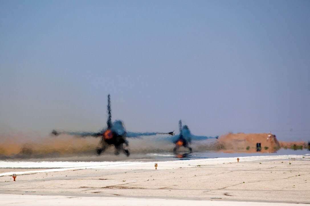 Two Jordanian F-16 Fighting Falcons take off as part of a scramble competition event between the Colorado Air National Guard and the Royal Jordanian Air Force. The Scramble tests the pilot and their crew chiefs in their ability to launch aircraft in a simulated quick response scenario during Eager Lion. Eager Lion is a U.S. Central Command-directed, irregular warfare-themed exercise focusing on missions the United States and its coalition partners might perform in support of global contingency operations. (U.S. Air National Guard Photo by Senior Master Sgt. John P. Rohrer)