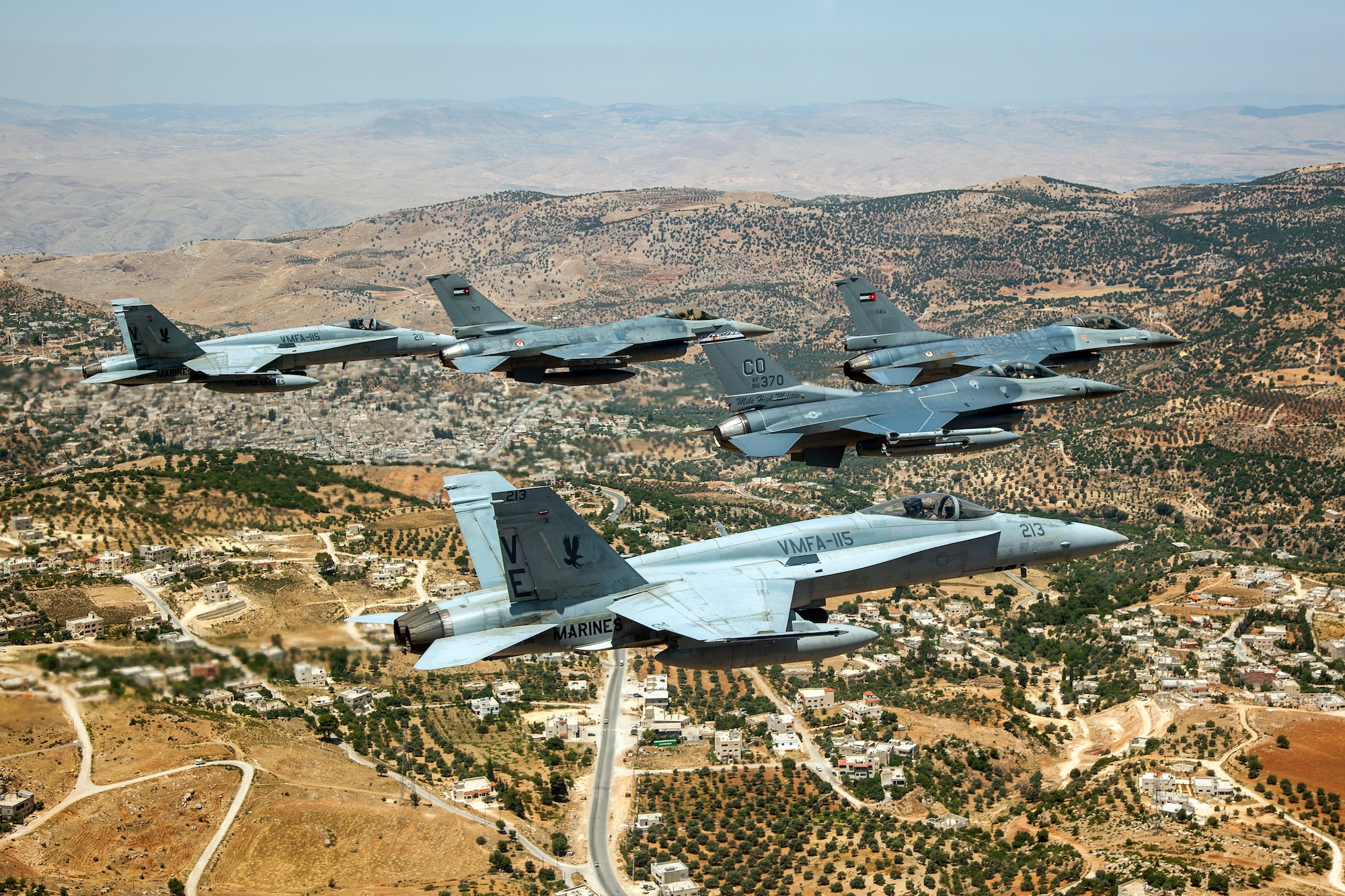 A Jordanian F-16 Fighting Falcon leads another Jordanian F-16, as well as an American F-16 from the120th Fighter Squadron, Colorado Air National Guard, and two Marine F-18's from VMFA-115 over the skies of Jordan. These aircraft represent some of the assets involved in the Eager Lion Exercise being held in Jordan. Eager Lion is a U.S. Central Command-directed, irregular warfare-themed exercise focusing on missions the United States and its coalition partners might perform in support of global contingency operations. (U.S. Air National Guard Photo by Senior Master Sgt. John P. Rohrer)