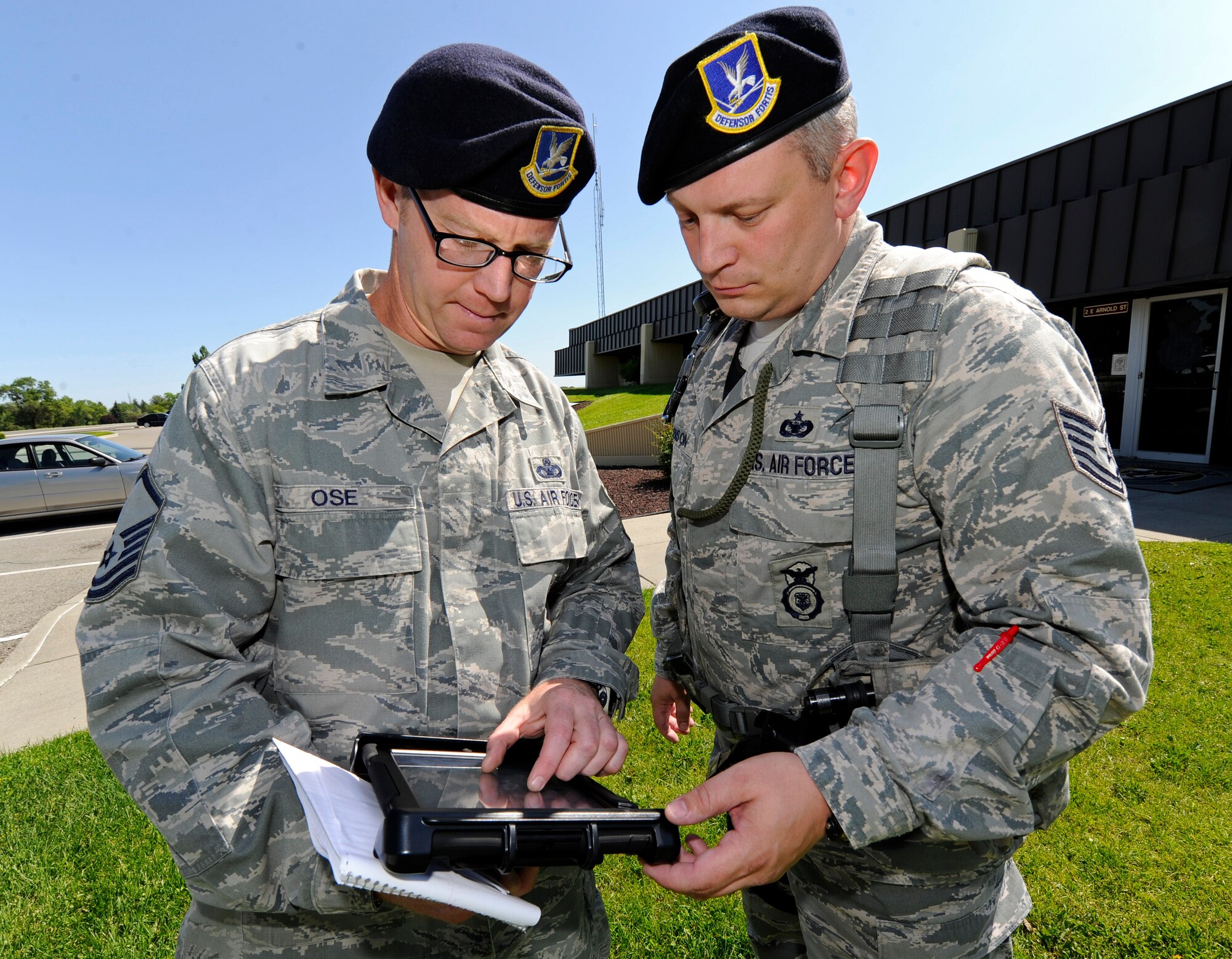 Master Sgt. Jamin Ose, 92nd Security Forces Squadron special project officer, and Tech. Sgt. Jeremy Robison, 92nd SFS flight sergeant, look for alerts on the map made possible with the access to an iPad with the AtHoc application at Fairchild Air Force Base, Wash., July 3, 2013. AtHoc is an interactive warning system used by the Air Force.  Fairchild has been selected as one of three bases to test the use of iPads with our emergency services. Using the AtHoc system with these devices will integrate first responders, police services and the fire department with shared information across the iPads. (U.S. Air Force photo by Airman 1st Class Ryan Zeski/Released)
