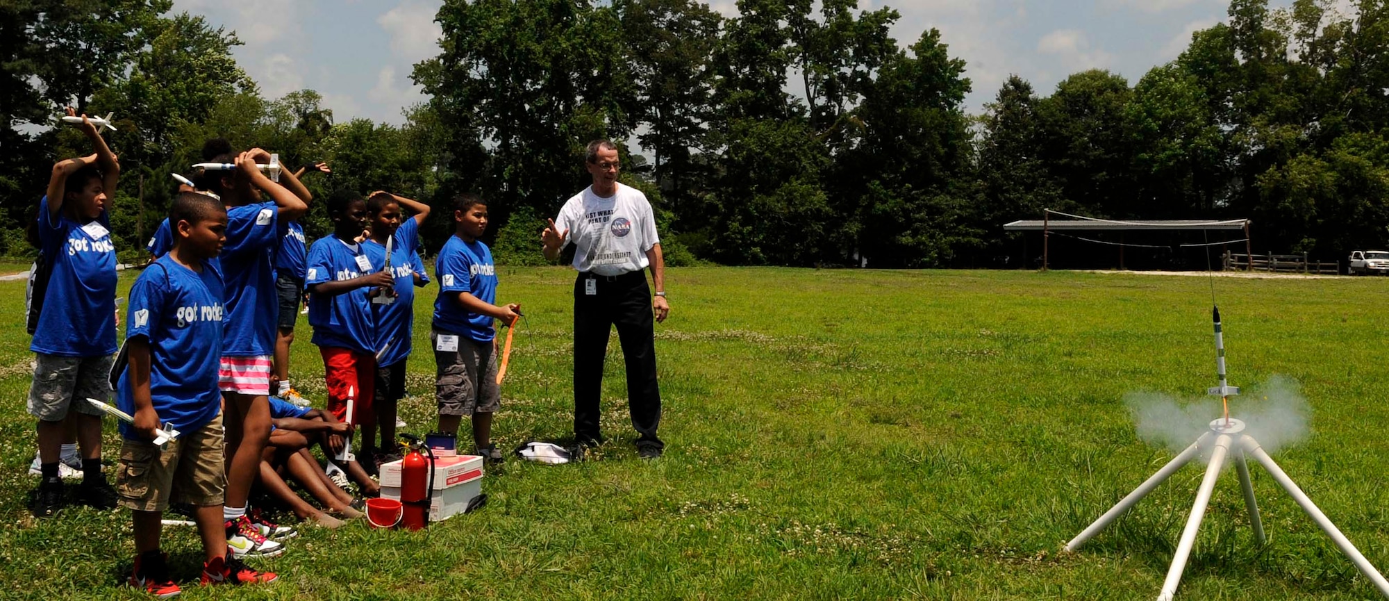 Children enrolled with the Langley summer youth program watch as they launch a model rocket during the Science, Technology, Engineering and Math Dream Team Camp at Bethel Park in Hampton Va., June 28, 2013. The weeklong camp is one of the many programs offered to children through summer youth programs at Joint Base Langley Eustis, Va. (U.S. Air Force photo by Staff Sgt. Dana Hill/Released)
