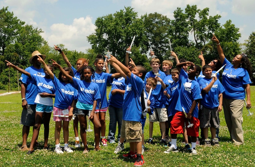 Children enrolled with the Langley summer youth program pose for a group photo during the Science, Technology, Engineering and Math Dream Team Camp at Bethel Park in Hampton Va., June 28, 2013. The weeklong camp is one of the many programs offered to children through summer youth programs at Joint Base Langley Eustis, Va. (U.S. Air Force photo by Staff Sgt. Dana Hill/Released)