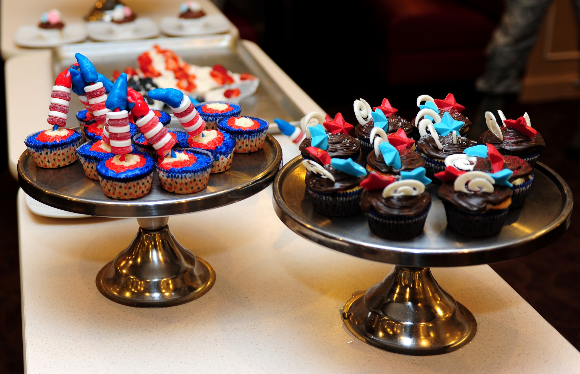Independence Day-themed cupcakes are on display before judging during the 633rd FSS Cupcake Challenge at the Langley Air Force Base Va., Crossbow Dining Facility, July 3, 2013. Participants were given two hours to bake and decorate one dozen each of two different flavors of cupcakes, which had to represent the Independence Day theme. (U.S. Air Force photo by Airman Areca T. Wilson/Released)