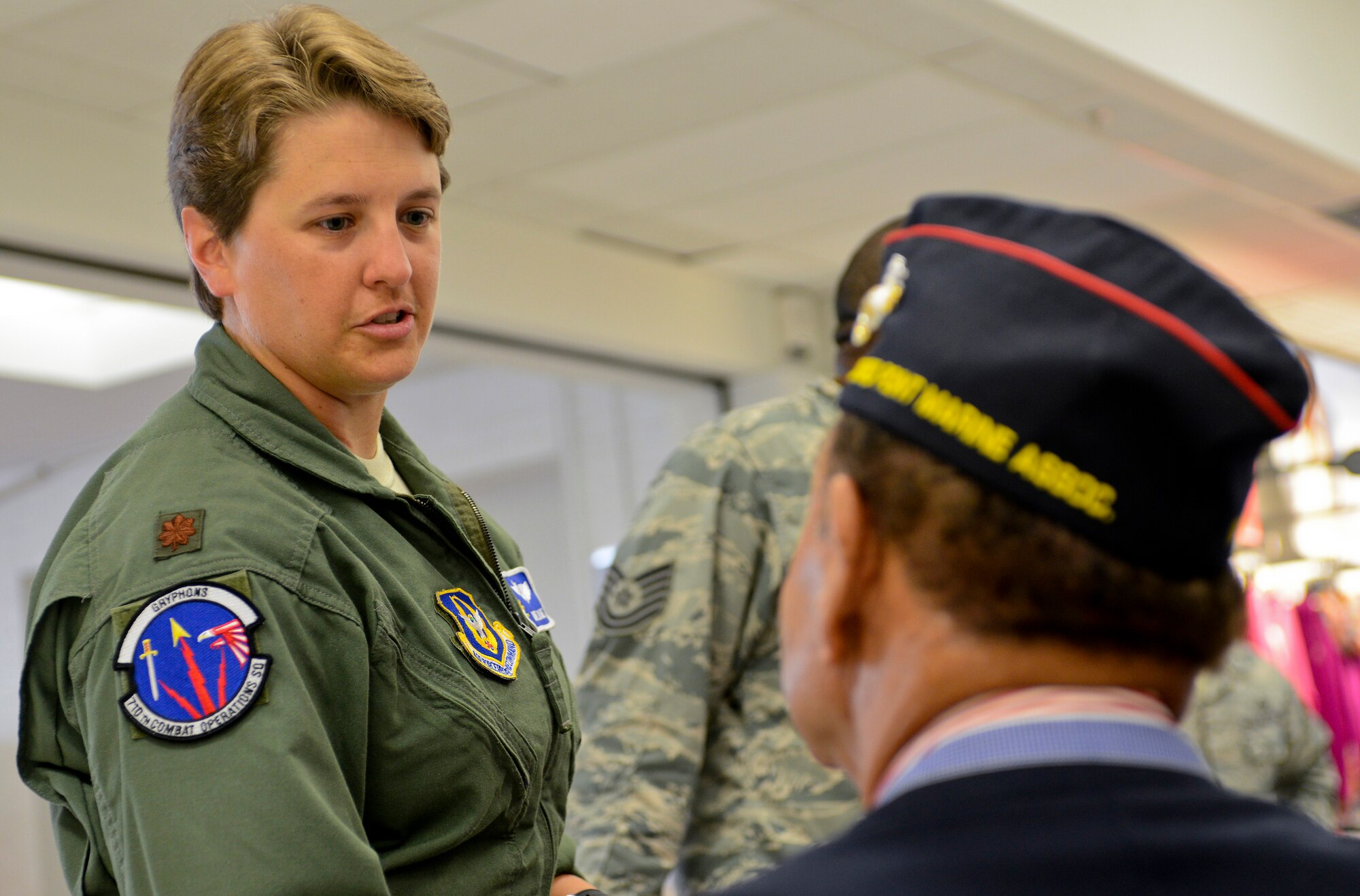 U.S. Air Force Maj. Dixie Duke, 710th Combat Operations Squadron assistant director of staff, speaks to a Montford Point Marine at the Exchange on Langley Air Force Base, Va., July 2, 2013. The retired Marines are part of the Tidewater chapter of the Montford Point Marine Association, a non-profit organization founded to memorialize the legacy of the first African-Americans to serve in the Marine Corps. (U.S. Air Force photo by Airman 1st Class R. Alex Durbin/Released)