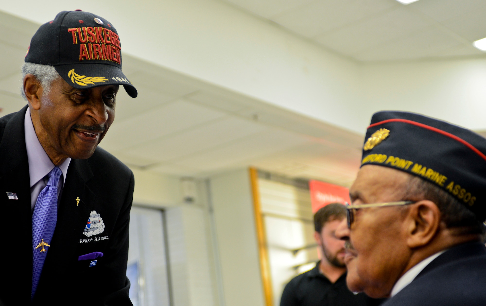 Ezra M. Hill, a Tuskegee Airman, speaks with Charles Norman, a Montford Point Marine, at the Exchange at Langley Air Force Base Va., July 2, 2013. Like the Tuskegee Airmen, the Montford Point Marines are considered trail blazers who broke the color barrier in the military, as they were the first African-American Marines trained at the segregated Camp Montford Point, N.C. (U.S. Air Force photo by Airman 1st Class R. Alex Durbin/Released)