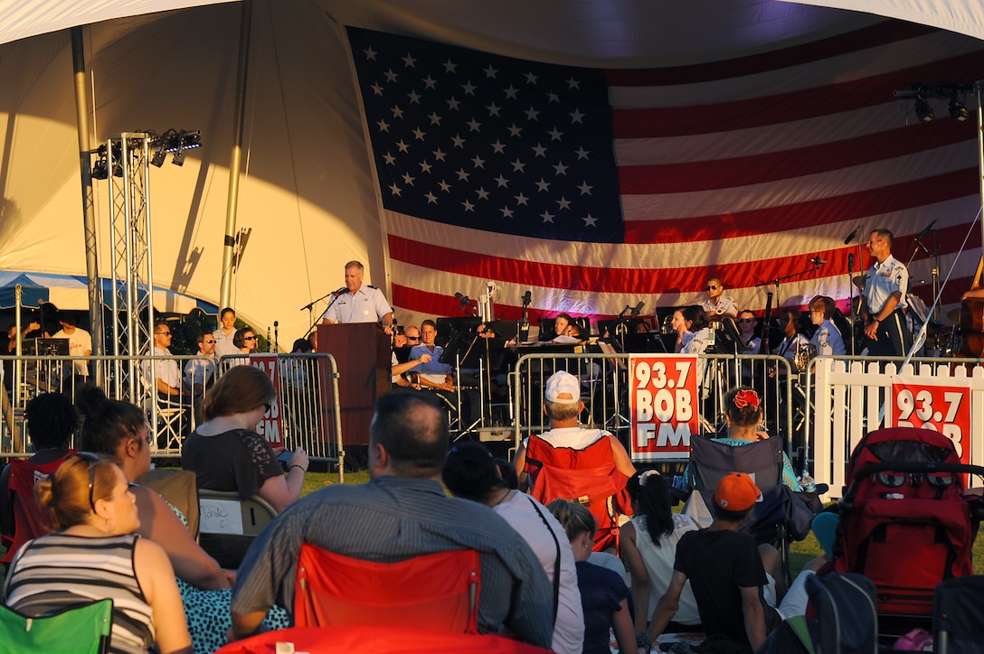 U.S. Air Force Col. John J. Allen, 633rd Air Base Wing commander, introduces the U.S. Air Force Heritage of America Band at the “Stars in the Sky” event at Victory Landing Park in Newport News, Va., July 4, 2013. More than 10,000 community members took part in the free event hosted by the Newport News Parks, Recreation and Tourism office. (U.S. Air Force photo by Airman 1st Class Victoria H. Taylor/Released)