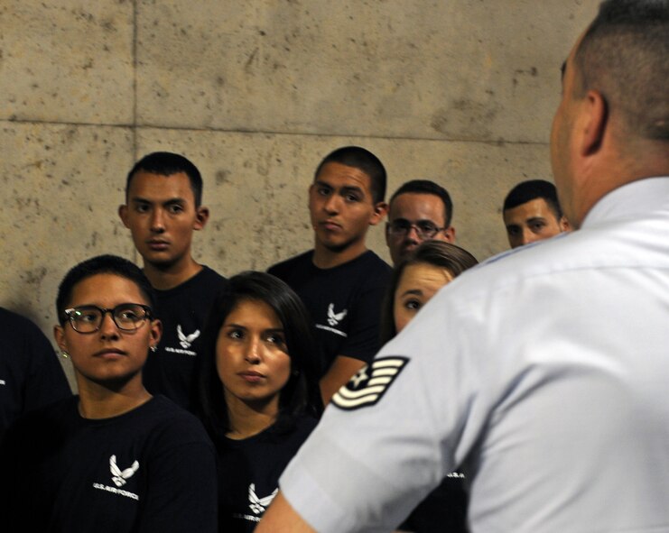 Elizabeth and Katherine Martinez, bottom left, listen to a recruiter before walking onto the field July 4, 2013, at Rangers Ballpark in Arlington, Texas. Air Force recruits from across Texas converged at Rangers Ballpark to participate in an Air Force enlistment ceremony. (U.S. Air Force photo by Airman 1st Class Peter Thompson/Released)