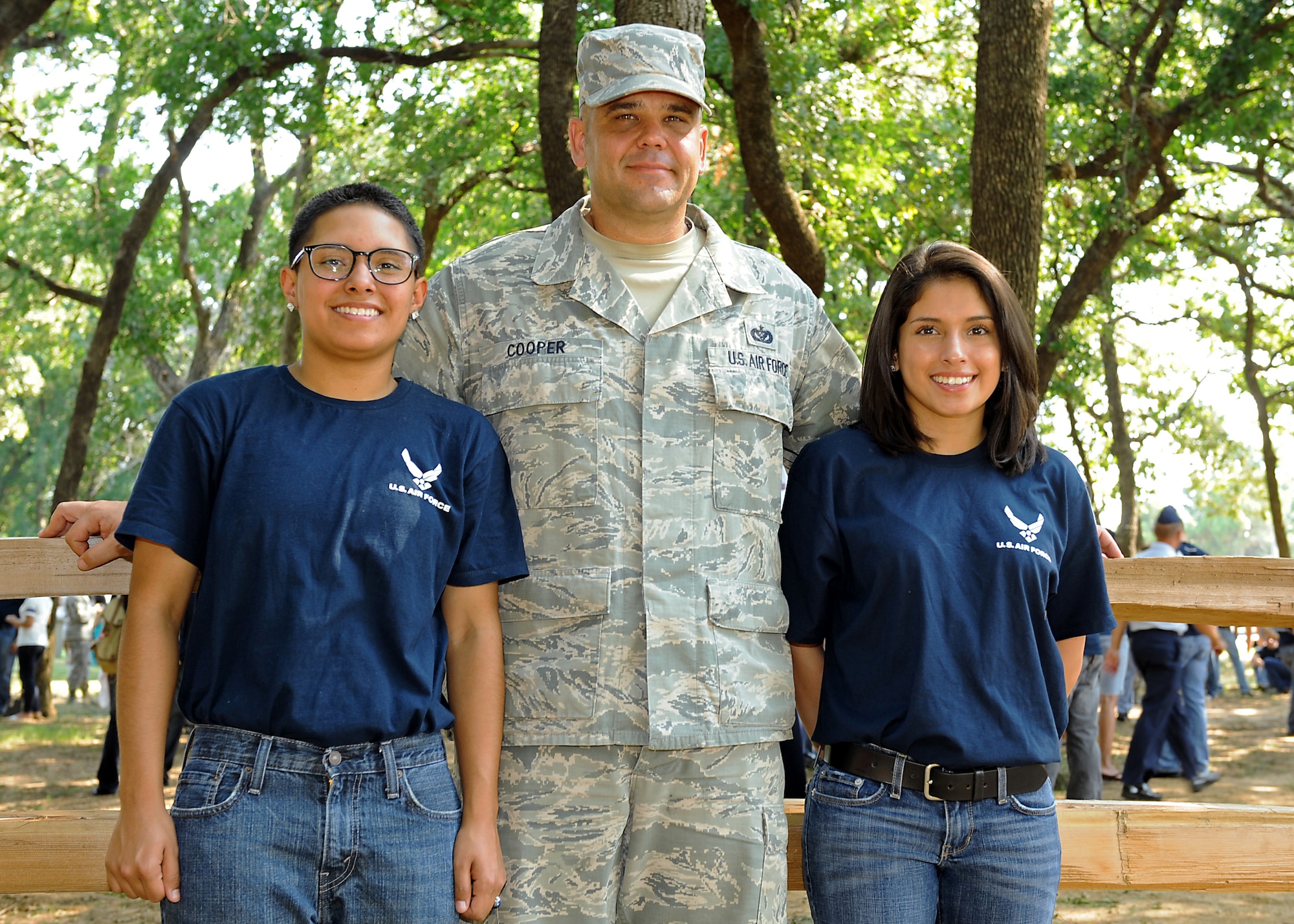 U.S. Air Force Tech. Sgt. Craig Cooper, 7th Civil Engineer Squadron, Dyess Air Force Base, Texas, stands with his stepdaughters Elizabeth Martinez, left, and Katherine Martinez July 4, 2013, outside of Rangers Ballpark in Arlington, Texas. Cooper and his daughters traveled to Arlington to participate in an Air Force enlistment ceremony on the Texas Rangers’ baseball field. (U.S. Air Force photo by Airman 1st Class Peter Thompson/Released) 