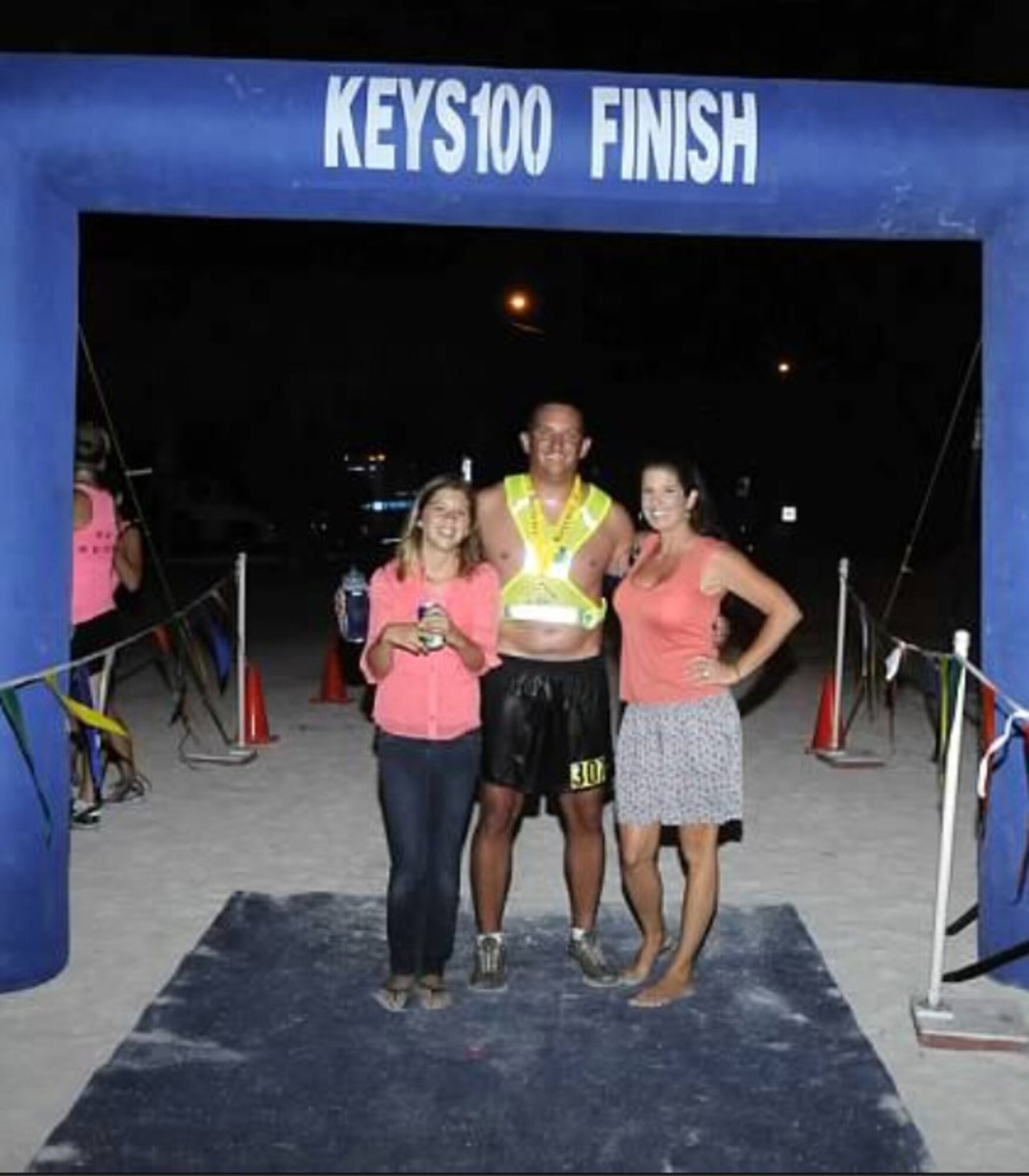 Combat-search-and-rescue pilot Capt. Jason Tomas, 920th Rescue Wing, Patrick Air Force Base, Fla., poses with his wife Kaili and 11-year-old daughter Alani after finishing a 50-mile ultra-marathon through the Florida Keys (the Keys100) May 19. (Courtesy photo)