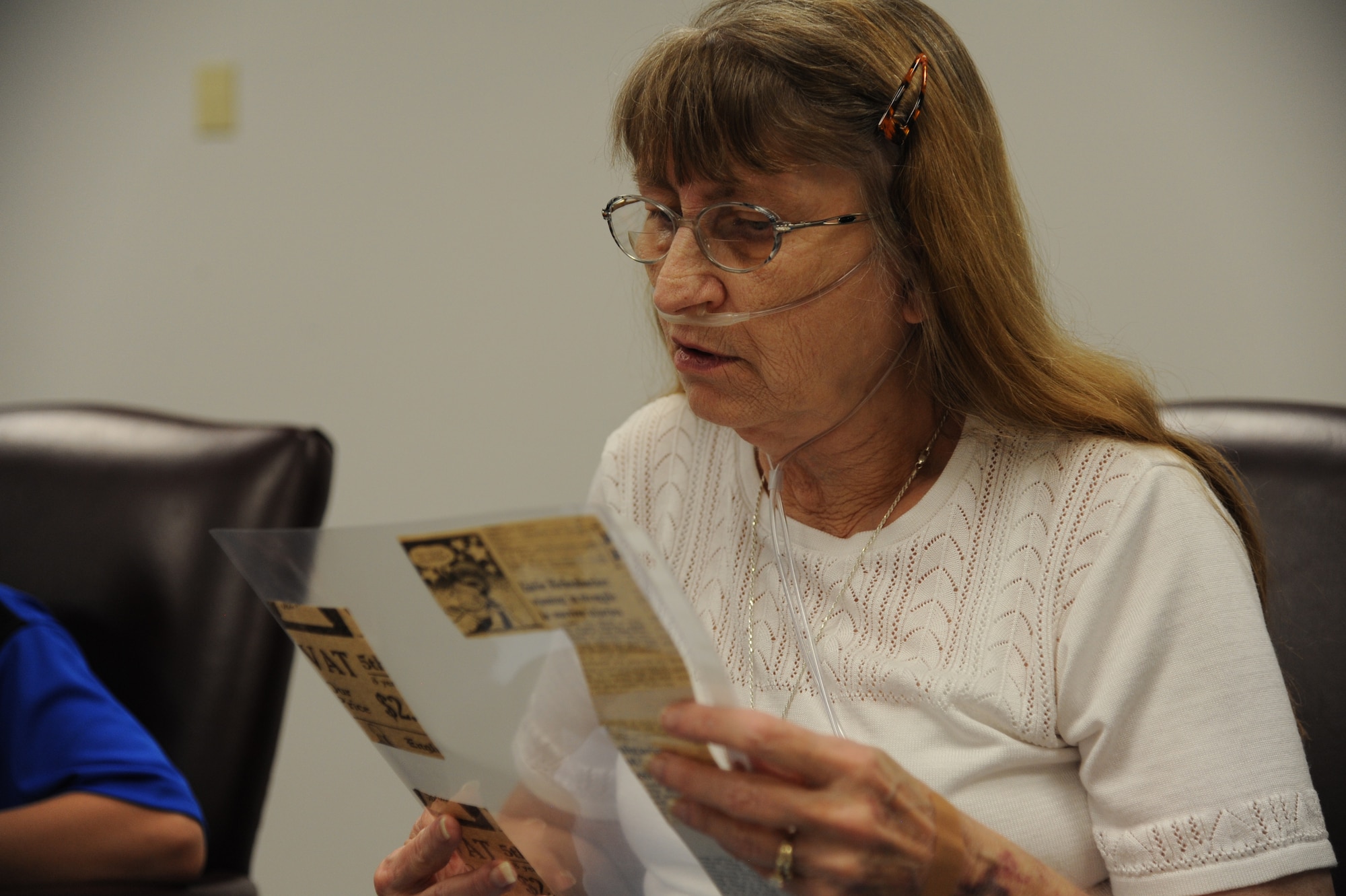 PETERSON AIR FORCE BASE, Colo. – Vicki Lea Huskey, daughter of Peterson AFB’s namesake, Lt. Edward Peterson, reads her parent’s wedding announcement clipped from a 1941 newspaper during her first-ever visit to the base, July 2. Vicki never knew her father as she was born after his death. Vicki and her family, from Wichita, Kan., spent the day touring the museum and myriad static displays learning everything they could about Lt. Peterson. They ended the day pouring over a table laden with Peterson’s personal effects. (U.S. Air Force photo/Staff Sgt. J. Aaron Breeden)