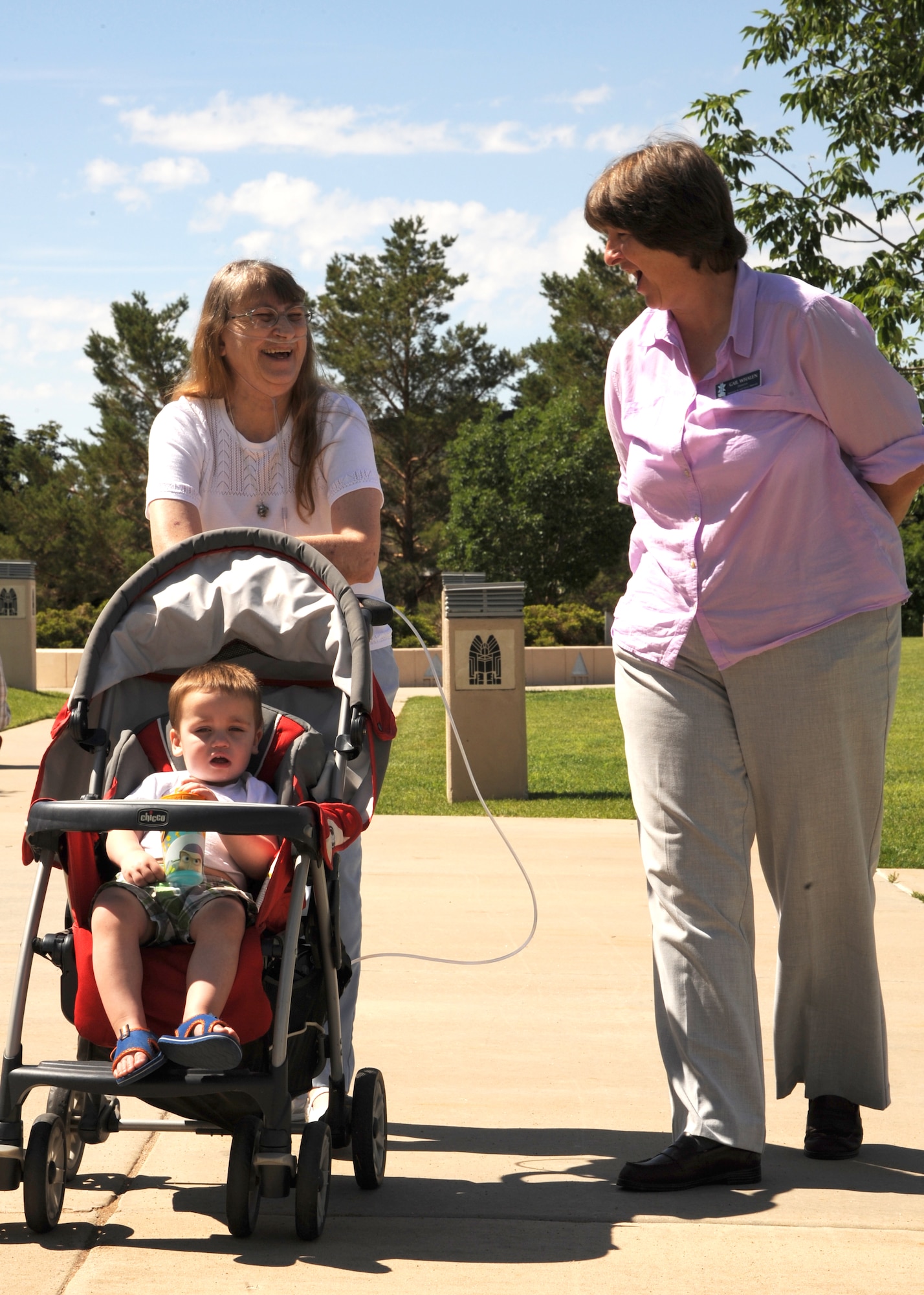 PETERSON AIR FORCE BASE, Colo. – Vicki Lea Huskey, daughter of Peterson AFB’s namesake, Lt. Edward Peterson, and Gail Whalen, Peterson Air and Space Museum director, share a laugh while reminiscing about Peterson’s life during Vicki’s first-ever visit to the base, July 2. Vicki never knew her father as she was born after his death. Vicki and her family, from Wichita, Kan., spent the day touring the museum and myriad static displays learning everything they could about Lt. Peterson. They ended the day pouring over a table laden with Peterson’s personal effects. (U.S. Air Force photo/Staff Sgt. J. Aaron Breeden)