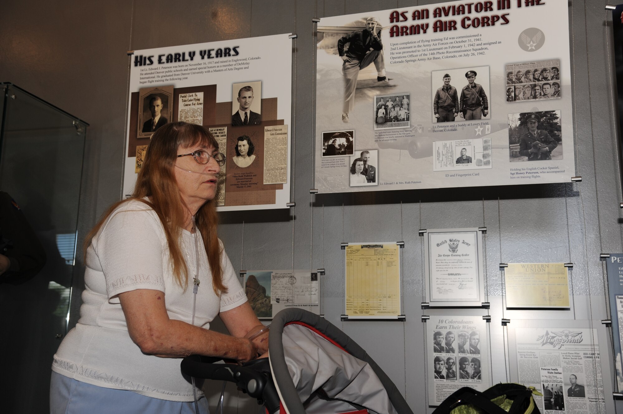 PETERSON AIR FORCE BASE, Colo. – Vicki Lea Huskey, daughter of Peterson AFB’s namesake, Lt. Edward Peterson, soaks in every detail about her father’s life during her first-ever visit to the base, July 2. Vicki never knew her father as she was born after his death. Vicki and her family, from Wichita, Kan., spent the day touring the museum and myriad static displays learning everything they could about Lt. Peterson. They ended the day pouring over a table laden with Peterson’s personal effects. (U.S. Air Force photo/Staff Sgt. J. Aaron Breeden) 