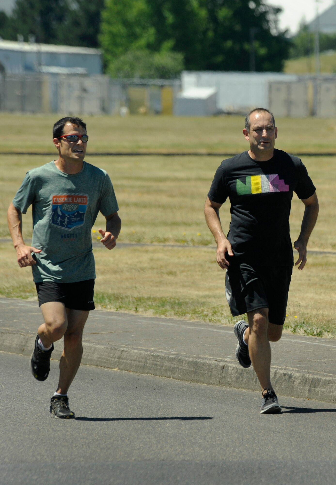 Oregon Air National Guard Col. Matthew Schuster, (right) Vice Commander, 142nd Fighter Wing and Executive Officer Maj. Frank Page (left) take off for an afternoon run at the Portland Air National Guard Base, Portland, Ore., July 3, 2013. Schuster’s workout routine helps him maintain a high level of fitness as an F-15 Eagle pilot for the Oregon Air National Guard. (Air National Guard Photo by Tech. Sgt. John Hughel, 142nd Fighter Wing Public Affairs/released)