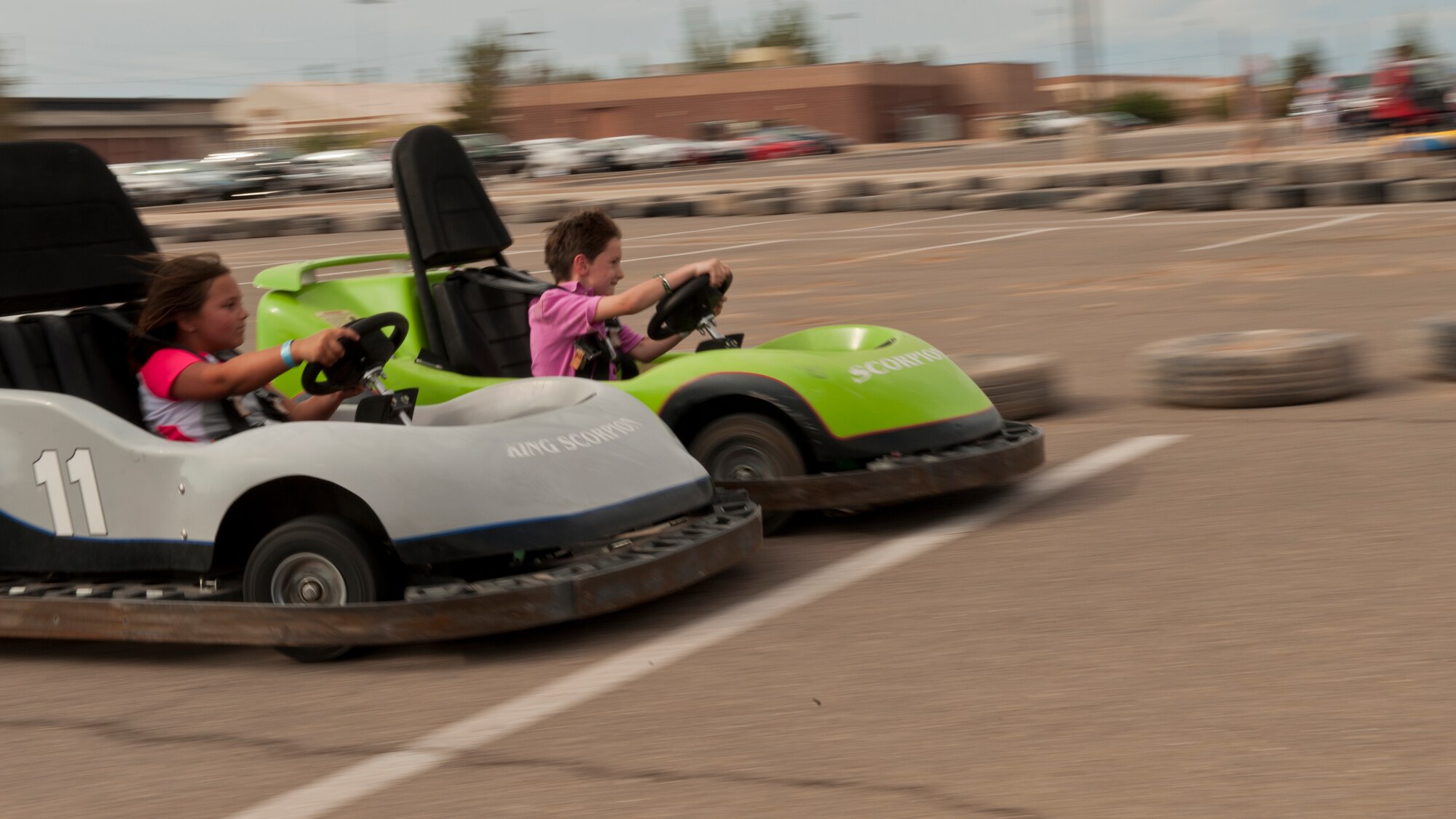 Two children cross the finish line in go carts during the Freedom Fest Independence Day celebration at Holloman Air Force Base, N.M., July 3. Freedom Fest took place in the Domenici Fitness and Sports Center parking lot and included carnival games, rides, and live music for Airmen and their families. (U.S. Air Force photo by Airman 1st Class Aaron Montoya/Released)
