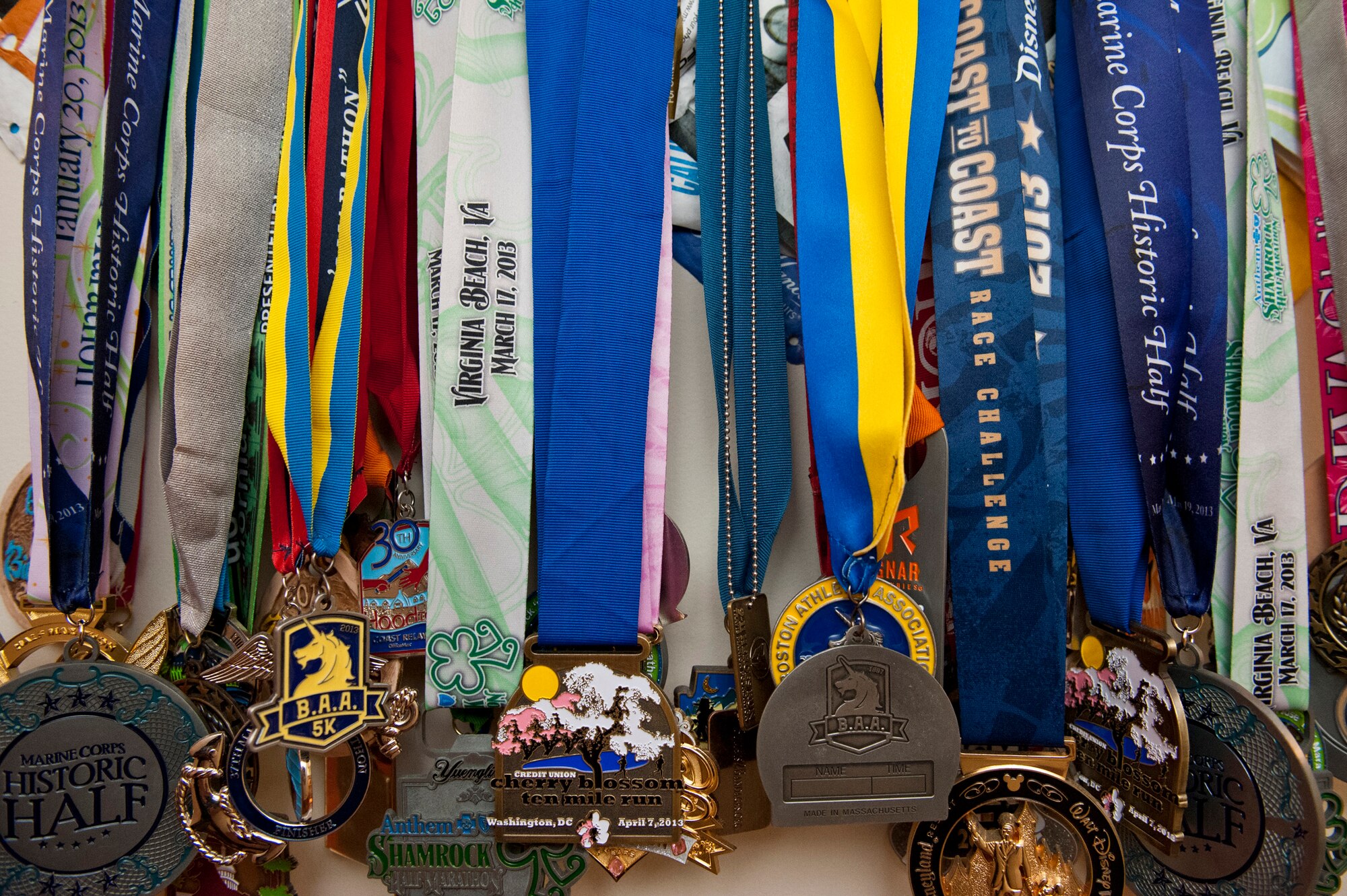 Running medals hang on the wall of Lt. Col. Ryan Novotny and Betsy Novotny's home, May 20, 2013 LOCATION. The medals are a symbol of all the effort they have put forth in living a healthy lifestyle. (U.S. Air Force Photo by Senior Airman Carlin Leslie)