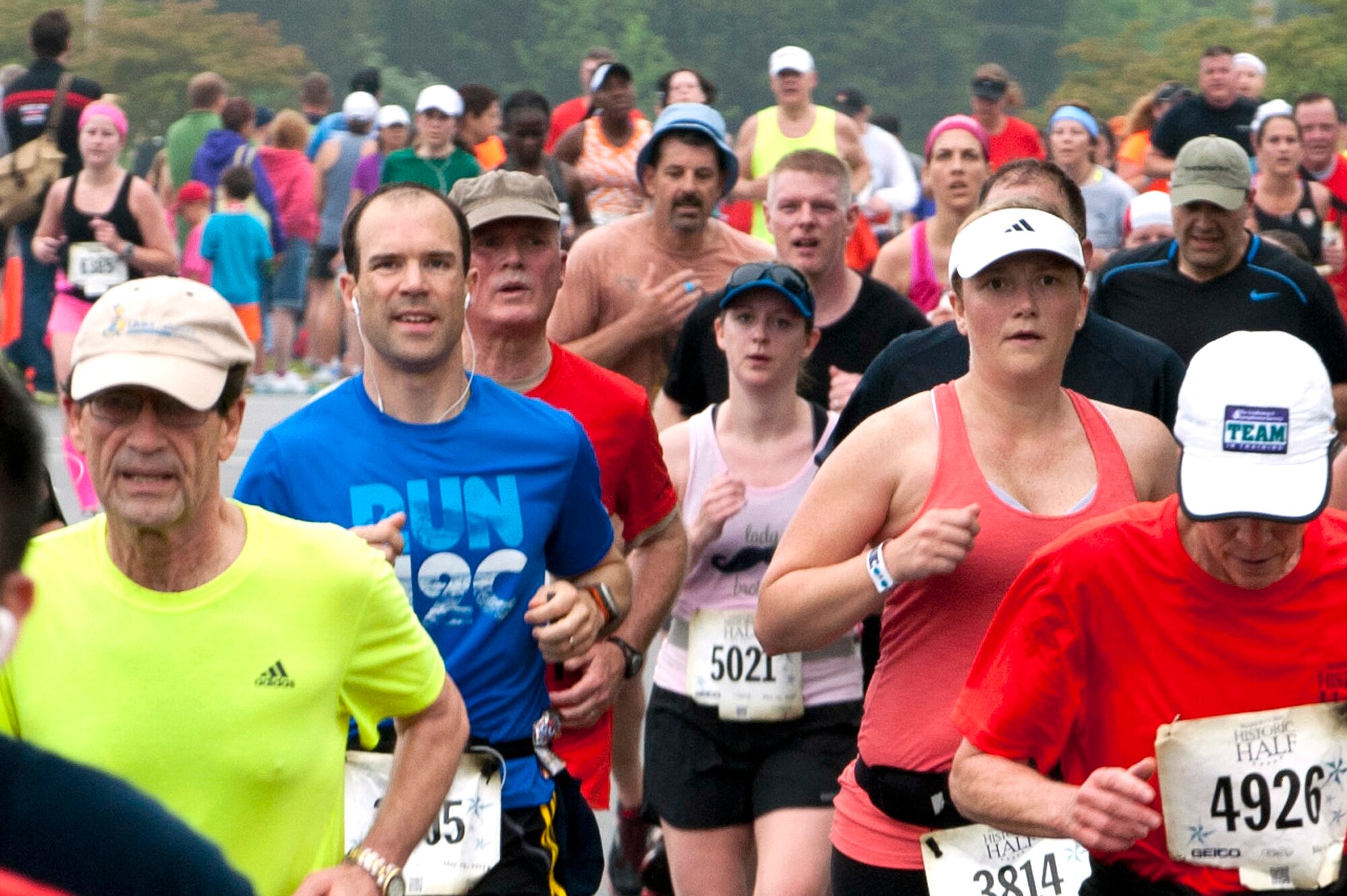 Lt. Col. Ryan Novotny (blue) and his wife Betsy (pink) head to the finish line during the Marine Corps Historic Half Marathon, in Fredericksburg, Va., May 19, 2013. The Novotny family strives to live a healthy lifestyle. (U.S. Air Force Photo by Senior Airman Carlin Leslie)