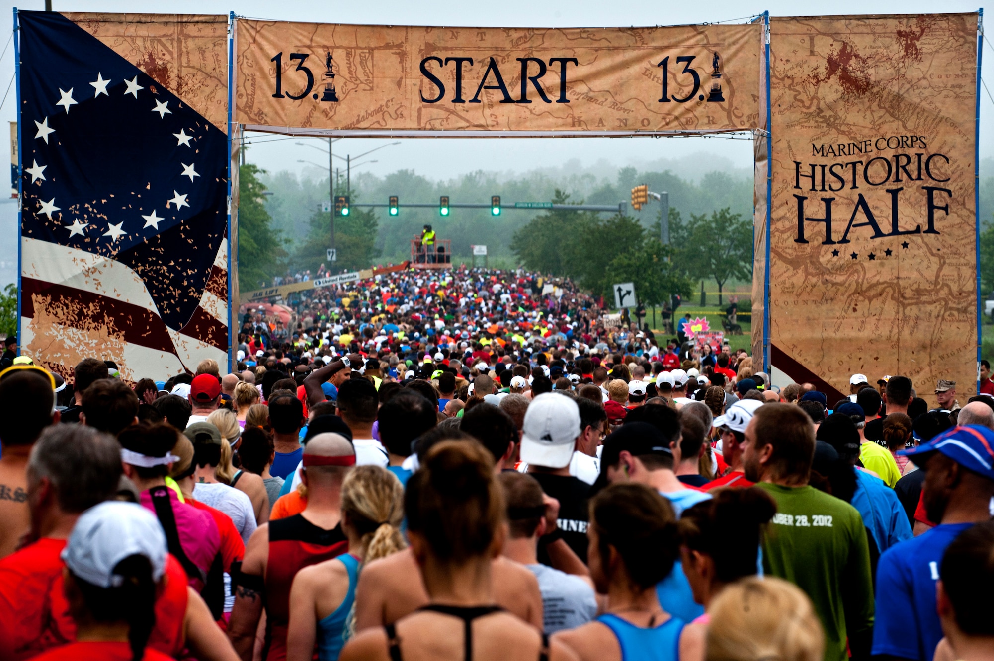 Runners take off through the starting line at the Marine Corps Historic Half Marathon, Fredericksburg, Va., May 19, 2013. Over 7,700 runners participated in the historic event, running in either the Semper Fred 5K, Historic 10K or the Marine Corps Historic Half. (U.S. Air Force Photo by Senior Airman Carlin Leslie)