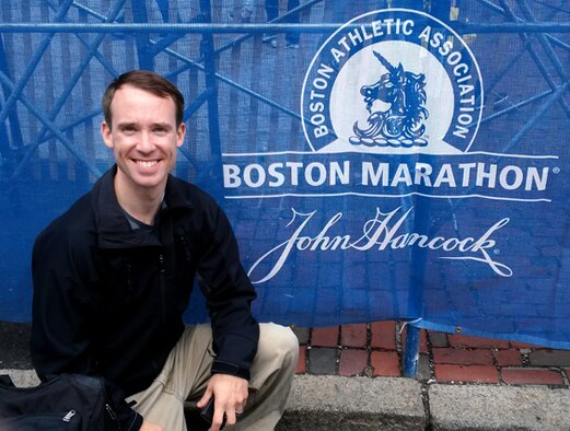 Maj. Reid Novotny kneels in front of a Boston Marathon logo the day before he and his brother, Lt. Col. Ryan Novotny, competed in the historic marathon. (Courtesy Photo)