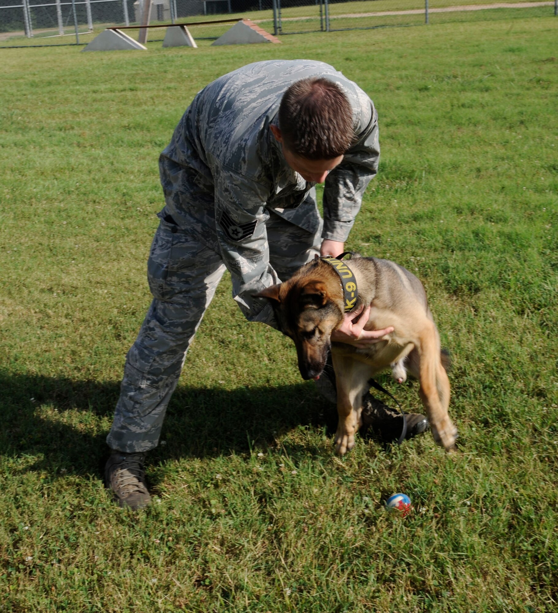 Staff Sgt. Jeremy Hammer, 2nd Security Forces Squadron military working dog handler, and Caro, 2nd SFS MWD, pose for a photo on Barksdale Air Force Base, La., July 8, 2013. Hammer is a MWD handler whose duties include detecting threats to Barksdale and deterring potential adversaries. (U.S. Air Force photo/Airman 1st Class Andrew Moua)