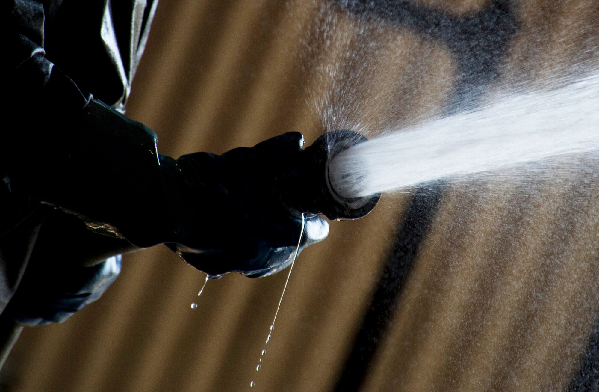 Airmen from the 5th Aircraft Maintenance Squadron wash a B-52H Stratofortess at Minot Air Force Base, N.D., June 19, 2013. The B-52s are washed routinely every 180 days to prevent corrosion and every 30 days in high corrosion areas. After the wash is completed, the post wash lube is used to force water and collected dirt out of high friction and moving areas. This keeps the parts functioning properly for safety during flight.  (U.S. Air Force photos/Senior Airman Brittany Y. Auld)