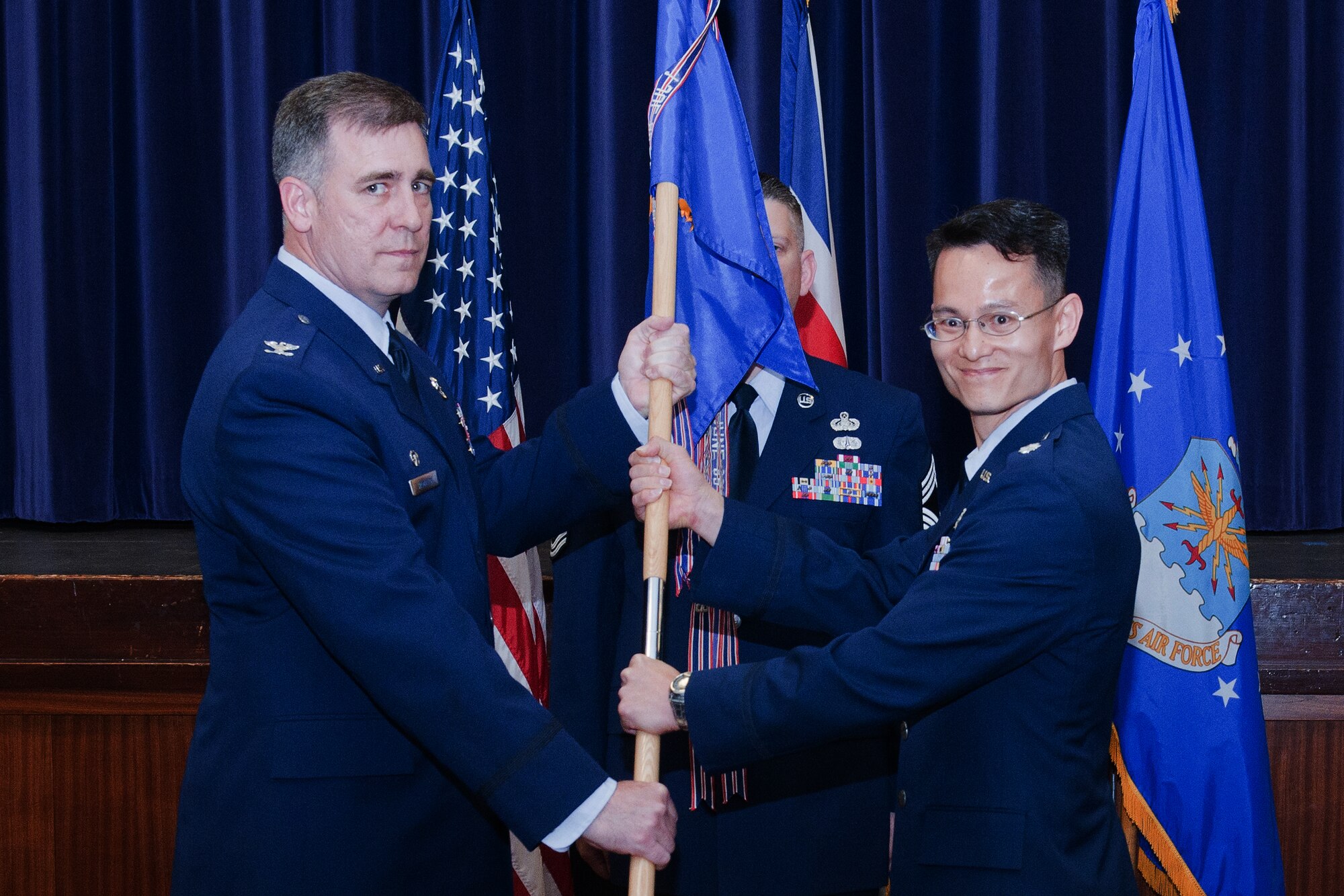 RAF CROUGHTON, United Kingdom - Lt. Col. Matthew Olson assumes command of the 422nd Communications Squadron from Col. Charles Hamilton, 422nd Air Base Group commander, in a change of command ceremony at the Community Activities Center July 8. (U.S. Air Force photo by Staff Sgt. Brian Stives)