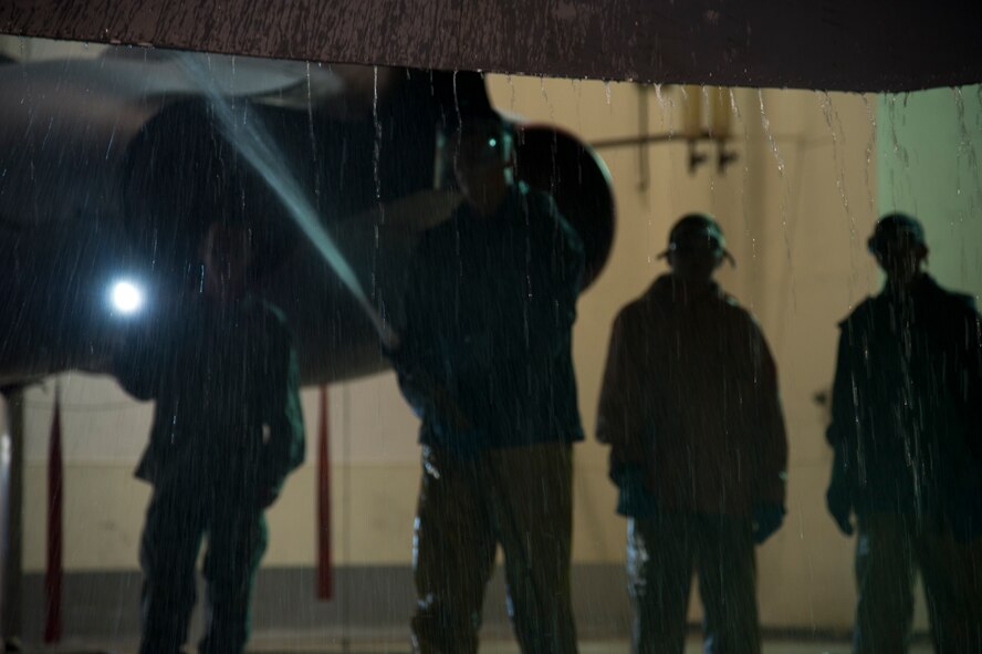 Airmen from the 5th Aircraft Maintenance Squadron wash a B-52H Stratofortess at Minot Air Force Base, N.D., June 19, 2013. The B-52s are washed routinely every 180 days to prevent corrosion and every 30 days in high corrosion areas. After the wash is completed, the post wash lube is used to force water and collected dirt out of high friction and moving areas. This keeps the parts functioning properly for safety during flight.  (U.S. Air Force photos/Senior Airman Brittany Y. Auld)