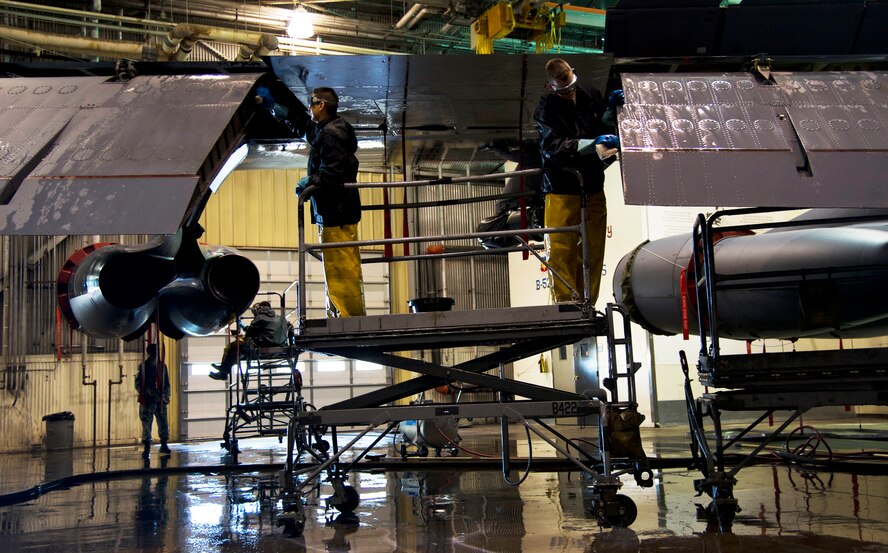 Airmen from the 5th Aircraft Maintenance Squadron wash a B-52H Stratofortess at Minot Air Force Base, N.D., June 19, 2013. The B-52s are washed routinely every 180 days to prevent corrosion and every 30 days in high corrosion areas. After the wash is completed, the post wash lube is used to force water and collected dirt out of high friction and moving areas. This keeps the parts functioning properly for safety during flight.  (U.S. Air Force photos/Senior Airman Brittany Y. Auld)