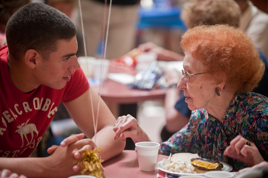 Airman 1st Class Manuel Hicks Jr., 791st Missile Security Forces Squadron response force member, visits with a resident of Trinity Homes in Minot, N.D., June 28. Hicks volunteered to help at a barbeque hosted by Friends of Veterans. (U.S. Air Force photo/Airman 1st Class Apryl Hall)